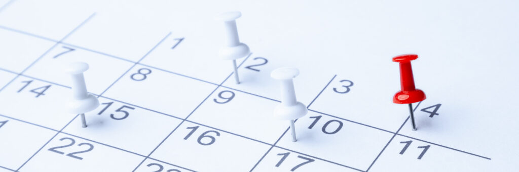 Photo of a calendar with pins on it